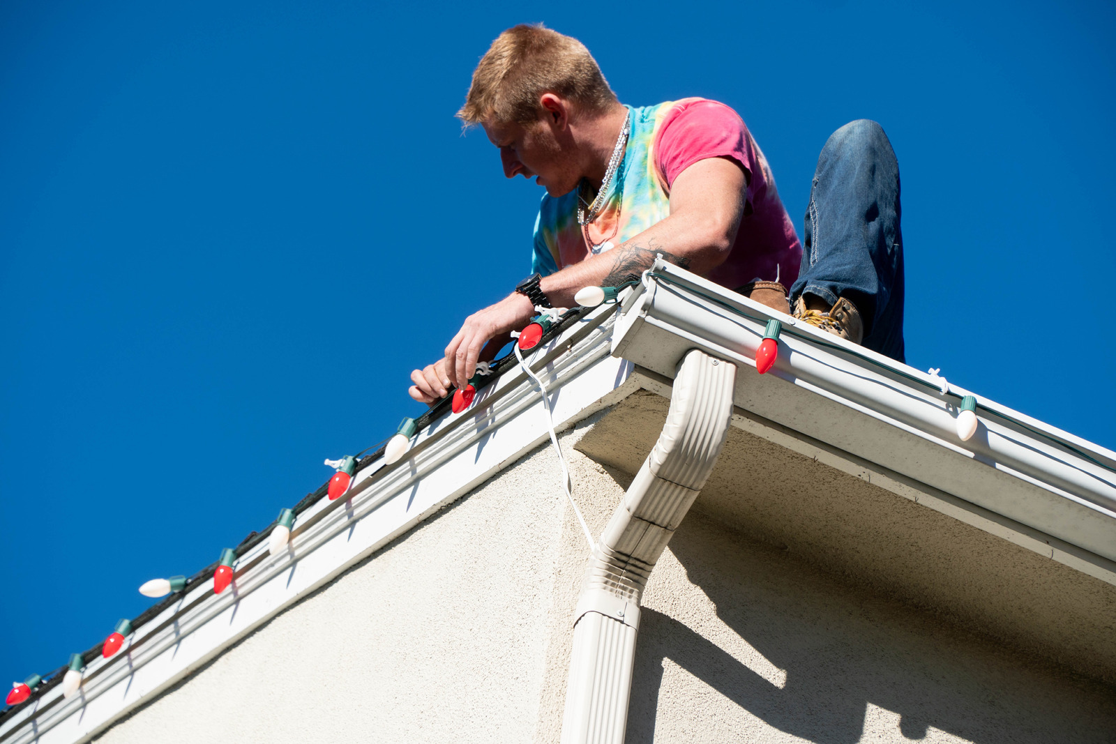 Patriot Pressure Washing team installing Christmas lights on a festive home